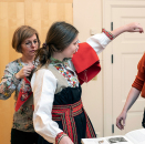 Trying on the bunad, assisted by Camilla Aspenes Goffeng and Thea Glimsdal Temte. Photo: Øivind Möller Bakken, The Royal Court